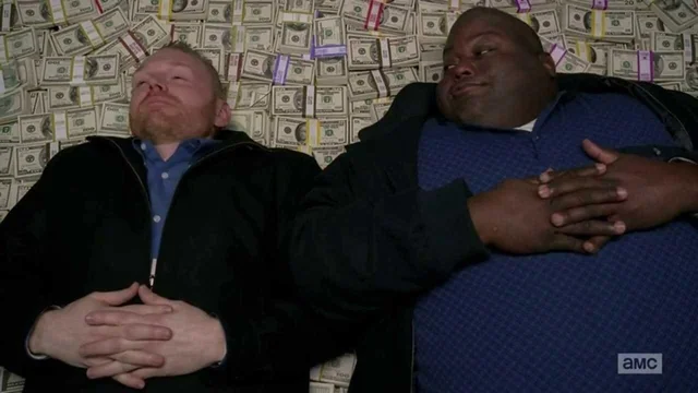 Huell and Kuby lying on a giant pile of cash in Breaking Bad.